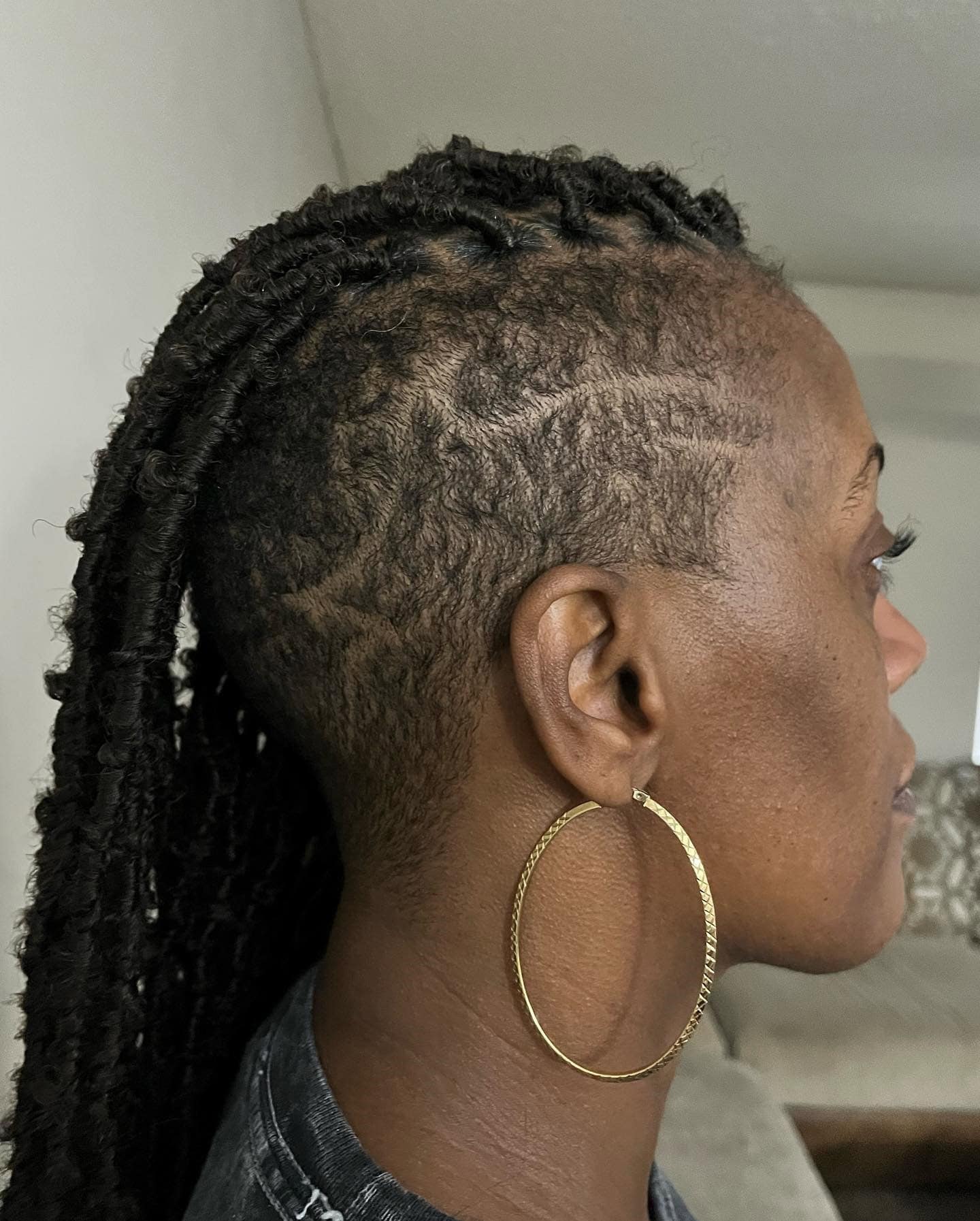 Distressed soft locs with a clean side shave.