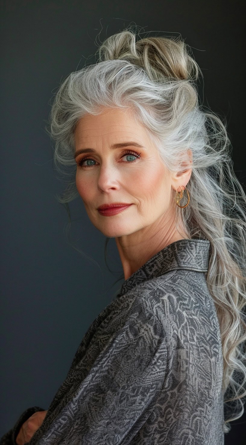 In this photo, a woman with a half-up half-down silver hairstyle poses with a serene expression.