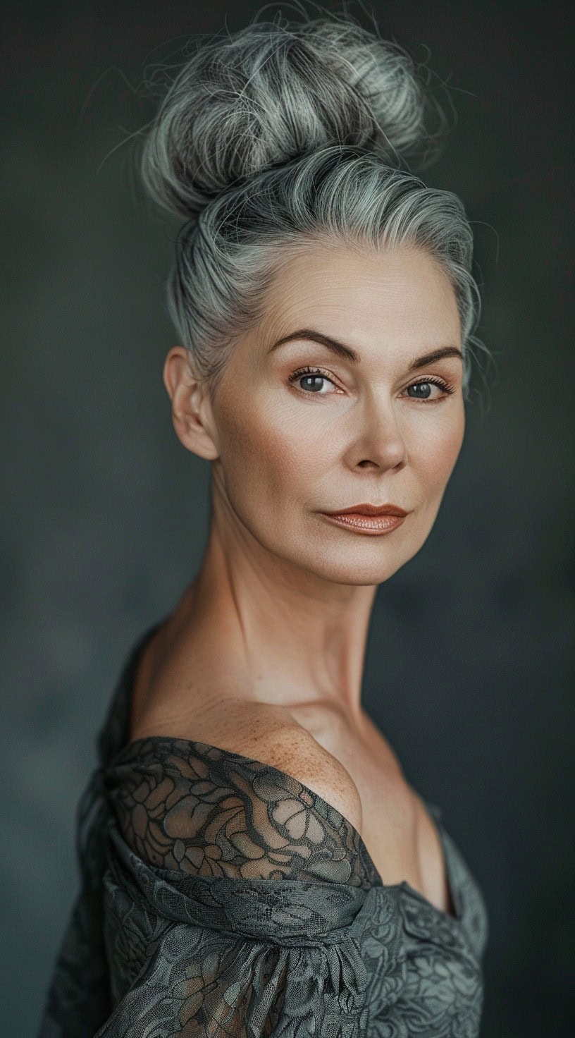 In this photo, a woman with a high silver bun gazes confidently.