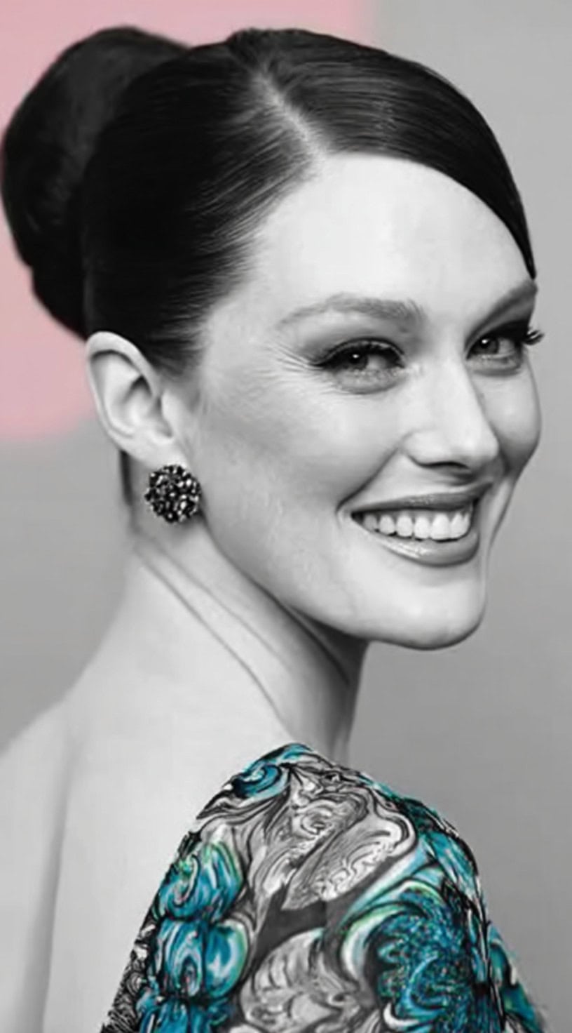 Dark hair styled into a high structured crown bun with a sleek, precise side part.