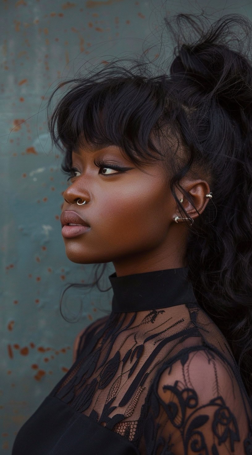 A woman with a high wavy ponytail and messy voluminous bangs.