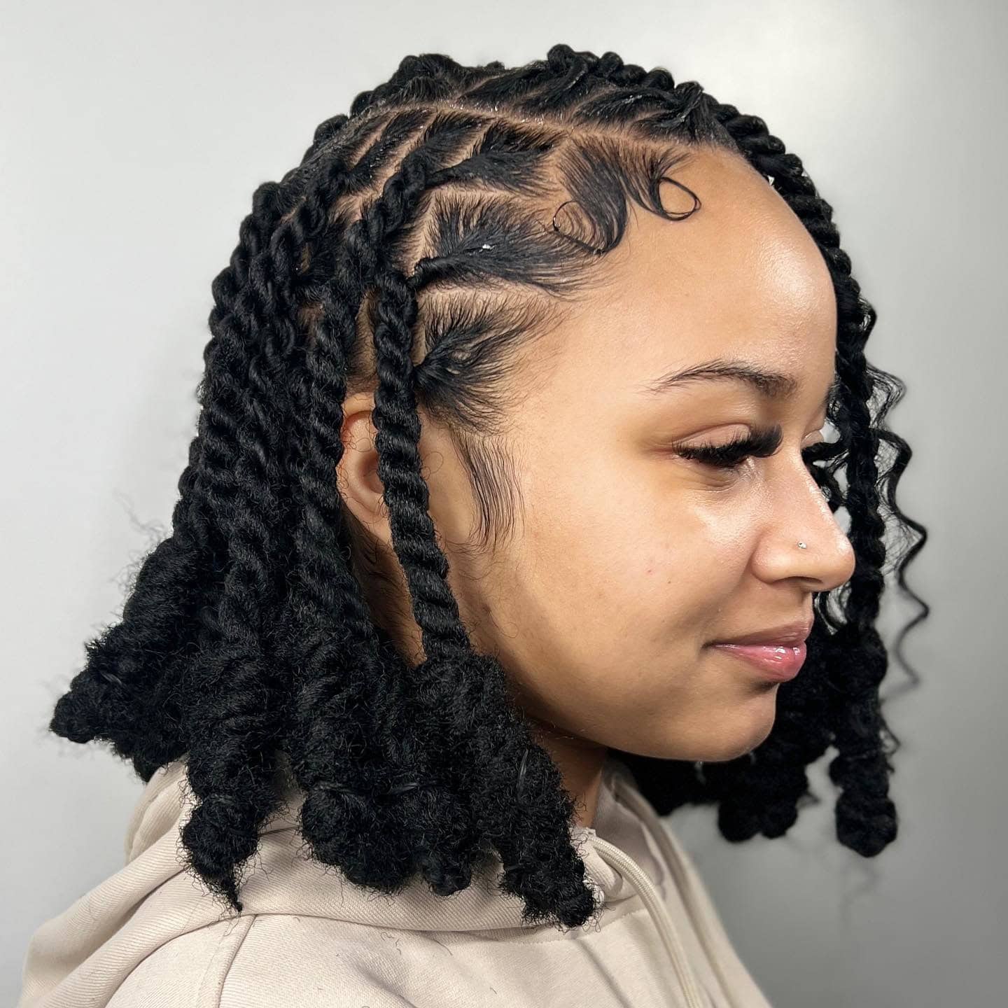 Invisible locs styled in a short bob with a neat and structured finish.