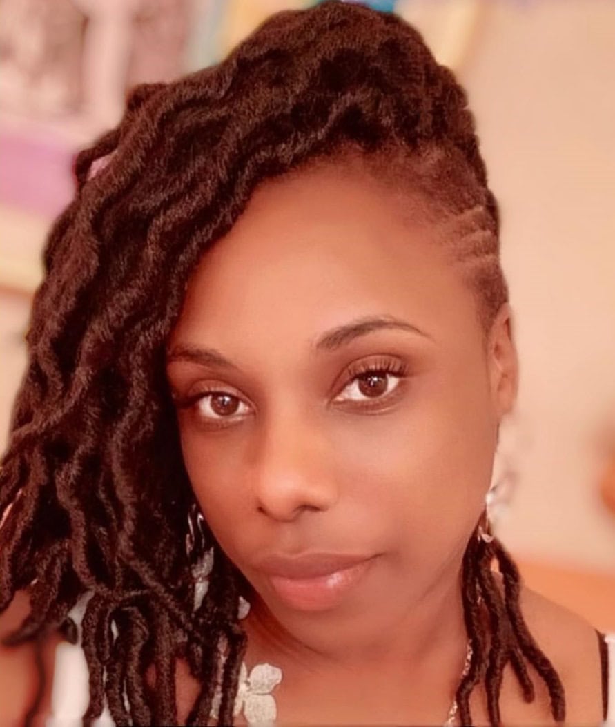 Locs with a side shave, styled in a soft, natural look.