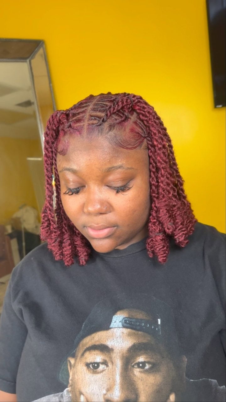 Short burgundy invisible locs with a V-shaped top for a bold and structured look.