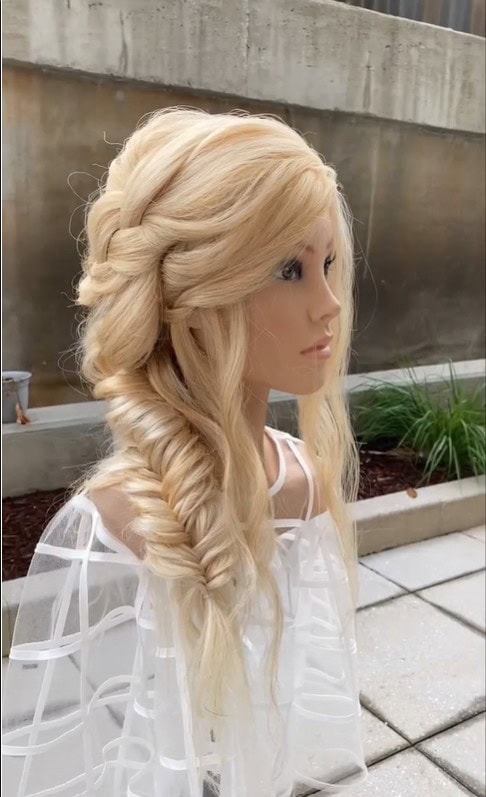 This image displays a cascading fishtail braid in a half-up, half-down hairstyle.