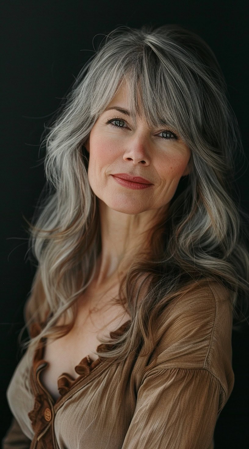 Side-swept bangs with added volume on top on a woman with a natural look.