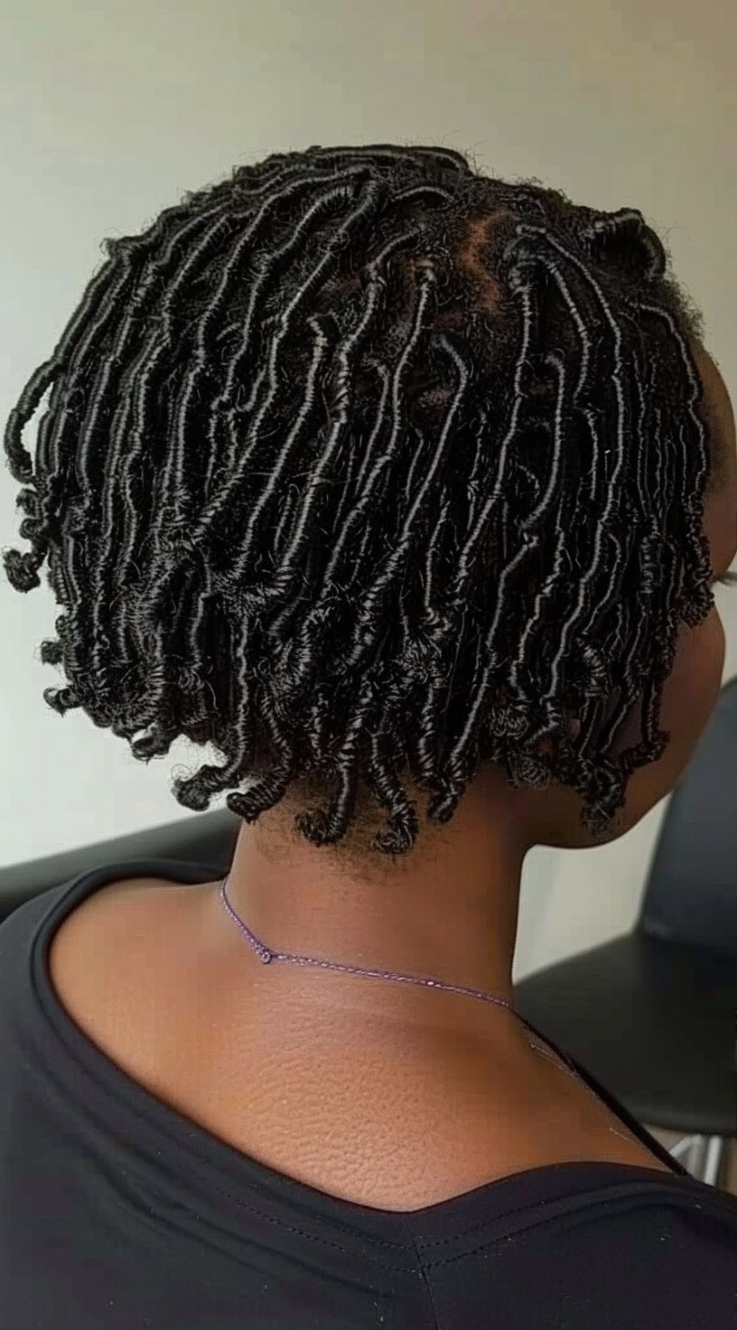 Short finger coils styled in a bob cut viewed from the back.