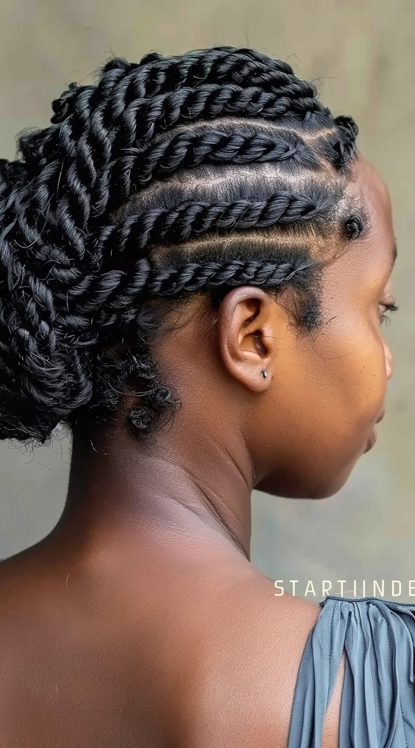 Flat twists are neatly twisted rows of hair, pulled back into a low bun, viewed from the back.