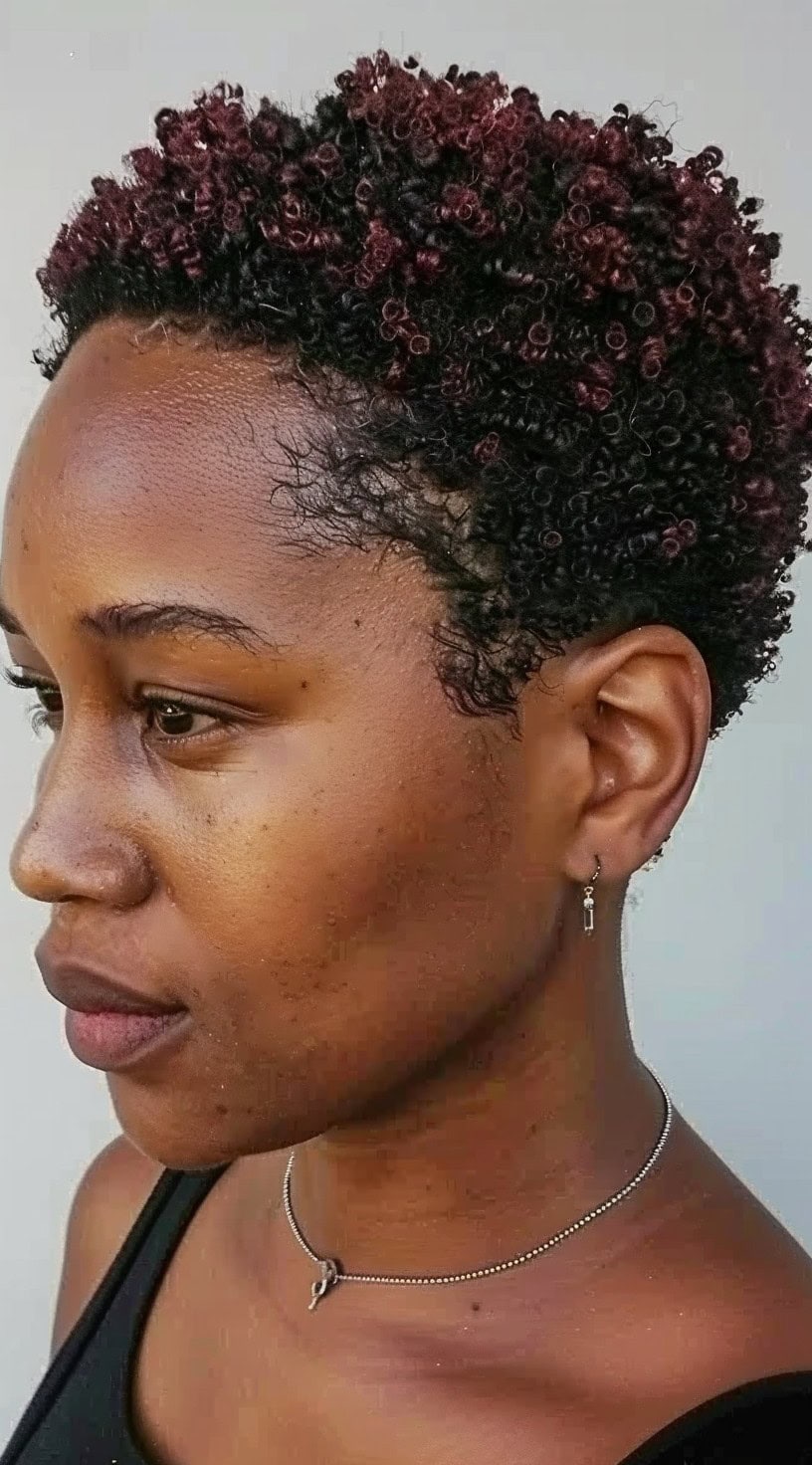 A woman with a highlighted TWA (teeny weeny afro) with micro curls.