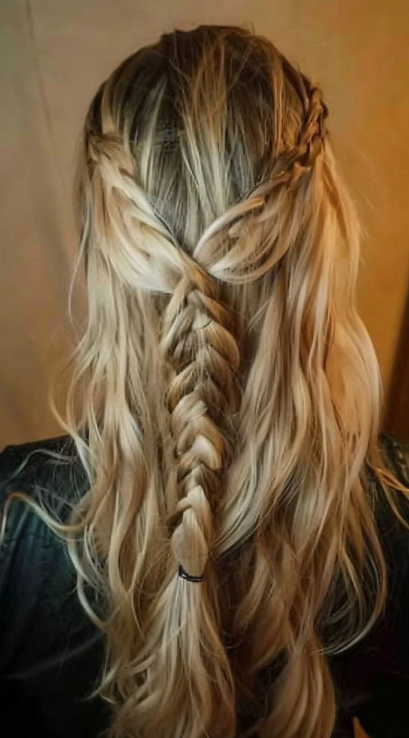 This photo shows a half-up hairstyle with an inverted fishtail braid.