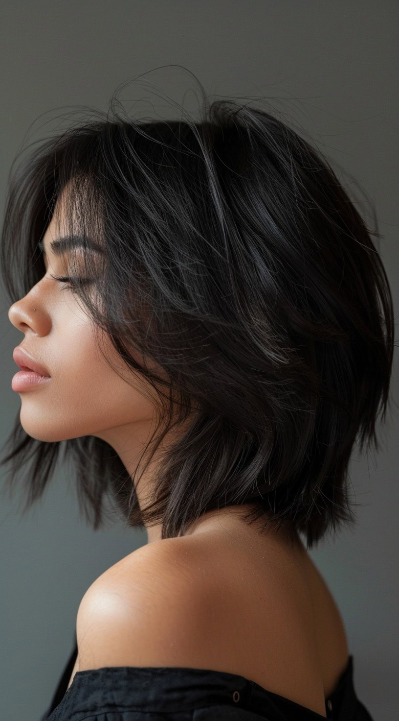 A woman with a textured long bob hairstyle is shown in the photo, featuring soft, tousled layers.