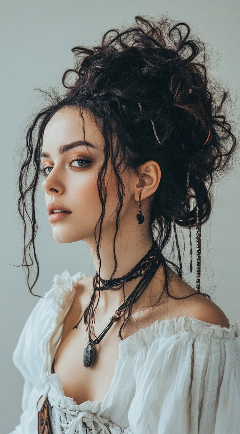 Young woman with a curly updo and loose strands framing her face, wearing pirate jewelry.