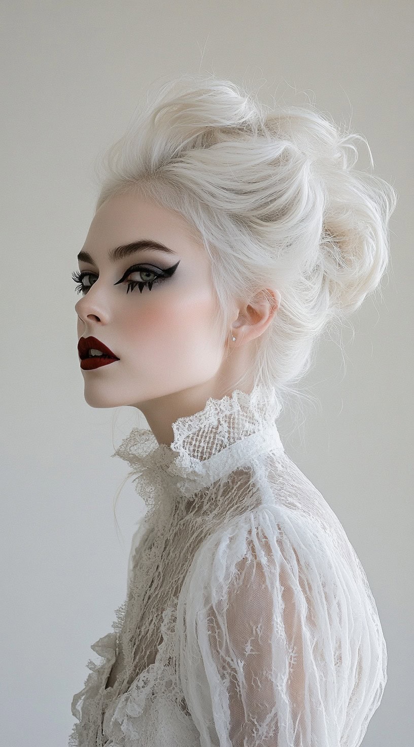 Side view of a woman with a voluminous platinum white updo and vampire makeup.