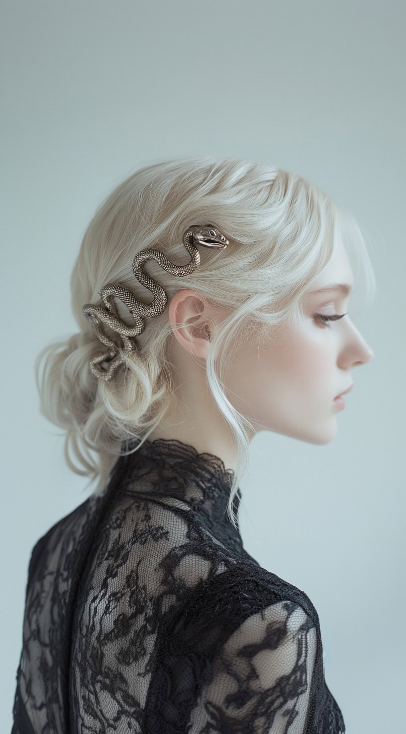 Profile of a woman with a soft, low bun adorned with a silver snake hair accessory.