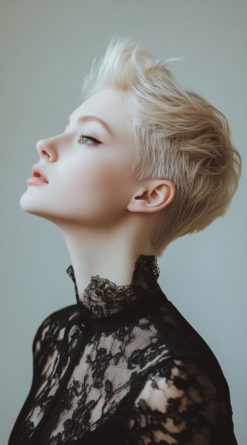 A woman with a textured pixie cut with height, wearing a lace high-neck top, showcasing a bold and elegant style.