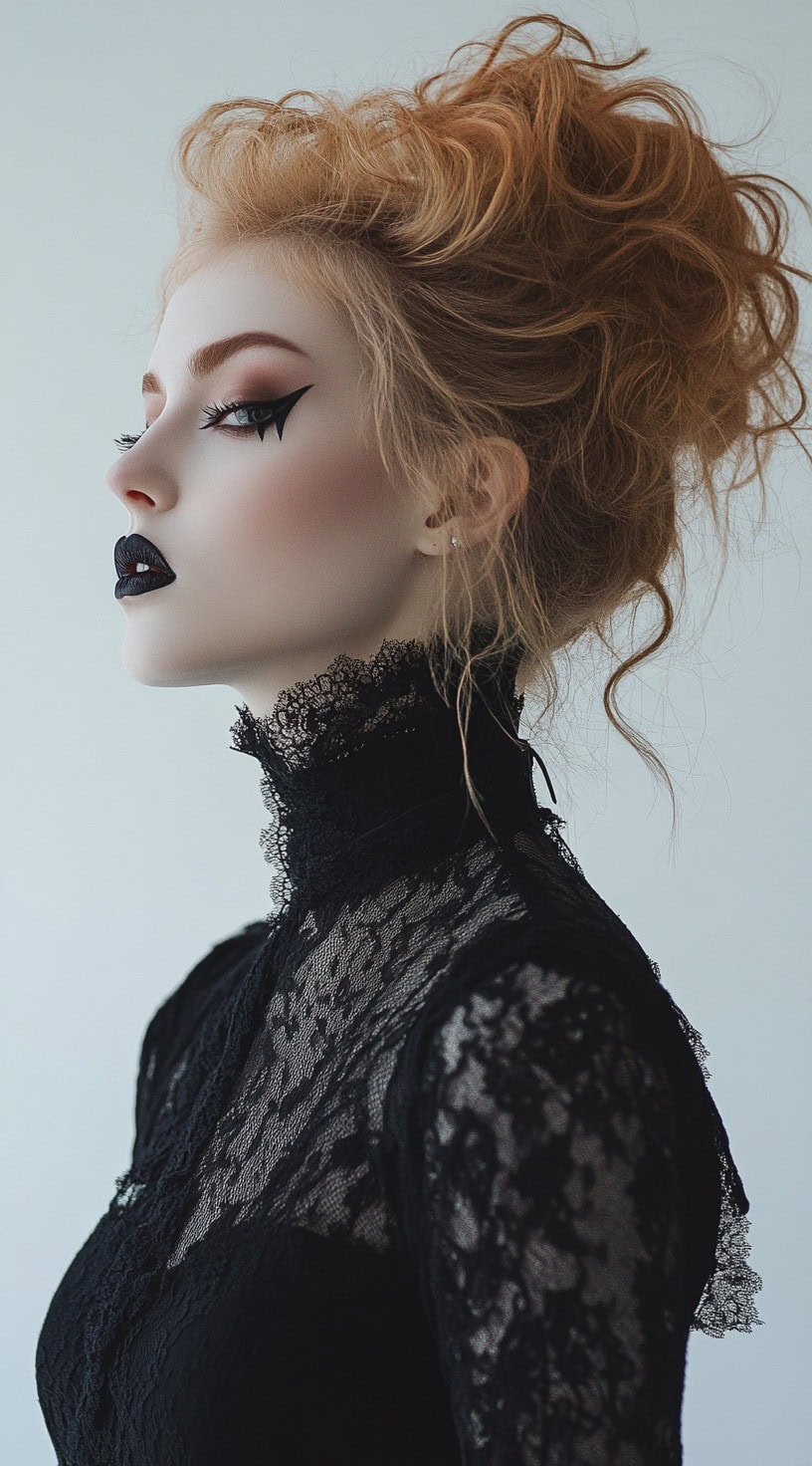 Side view of a woman with a voluminous updo made of natural curls, styled with vampire makeup.