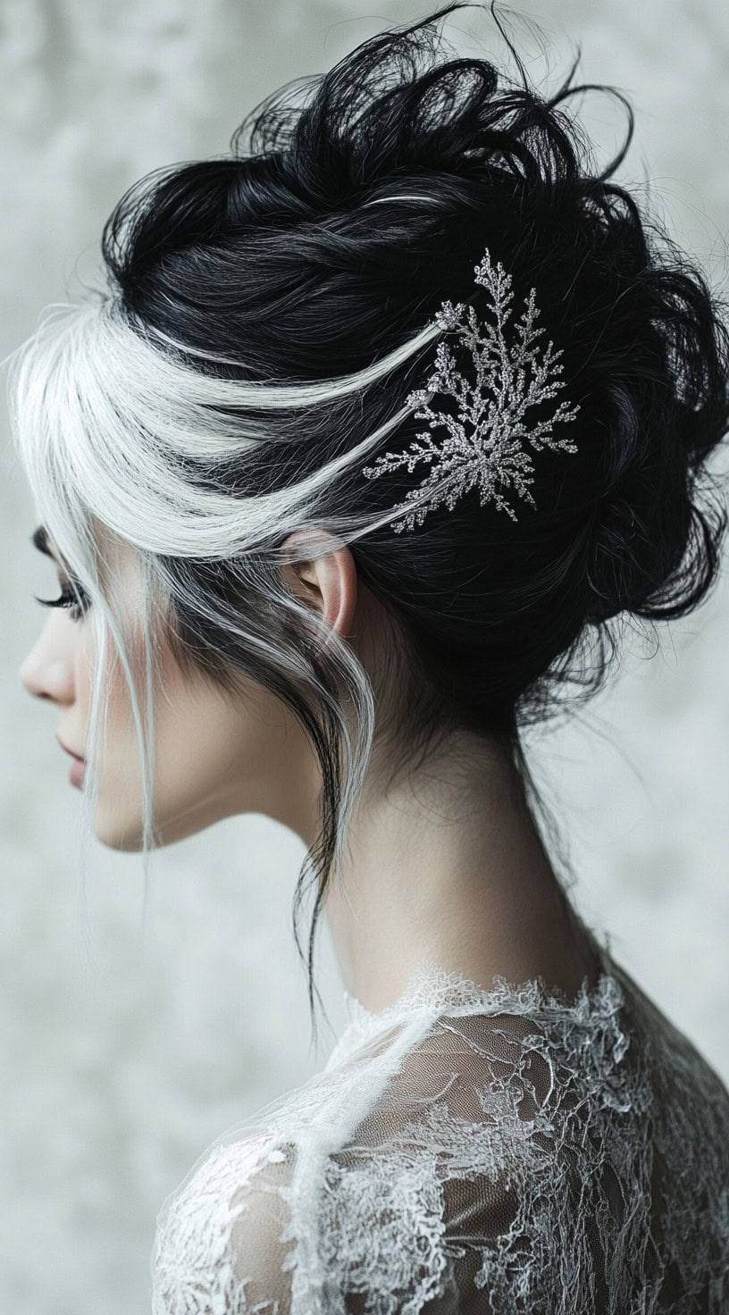 This photo shows a woman with a voluminous updo featuring platinum blonde streaks and snowflake hair accessories.