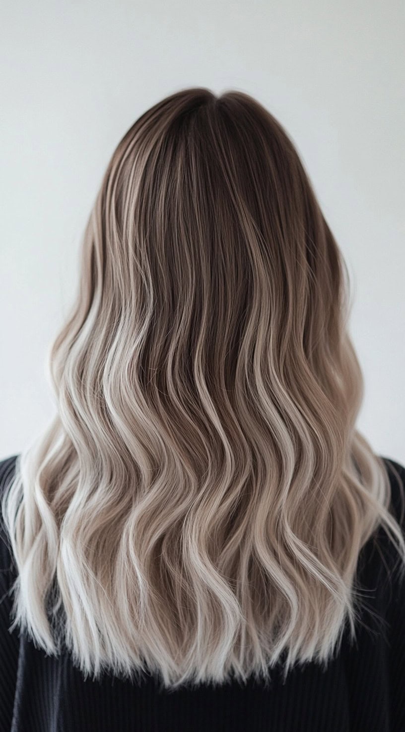 Medium-length wavy hair with ash blonde balayage and brunette base.