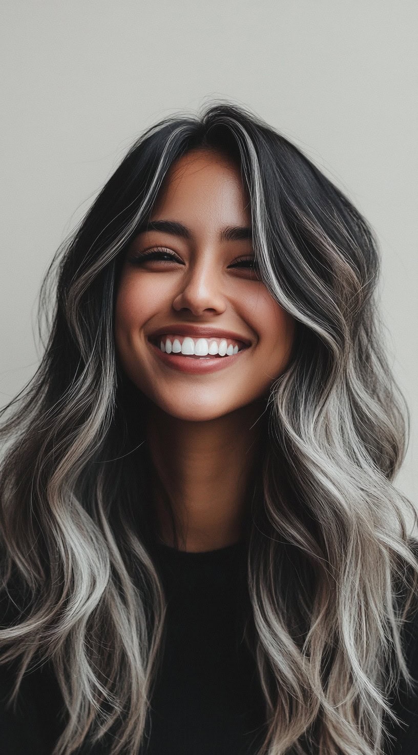 Long wavy hair with dark brunette base and ash blonde highlights.
