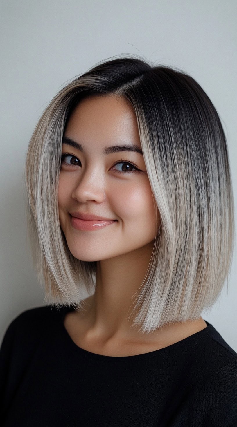 Sleek, straight lob with dark brunette roots blending into ash blonde.