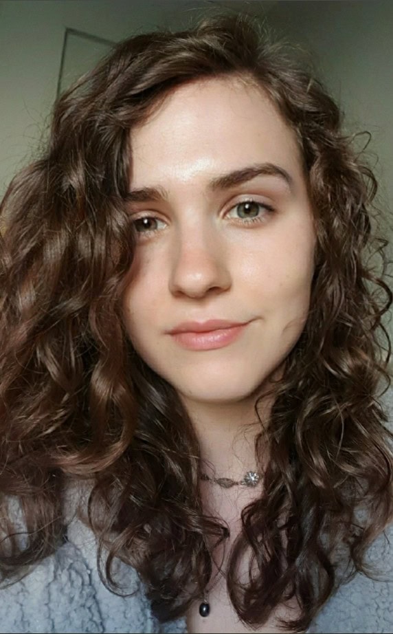 Fine medium-length hair styled in soft curls that add bounce and gentle shape to a natural texture.